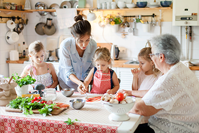 A mother preparing a meal with her children